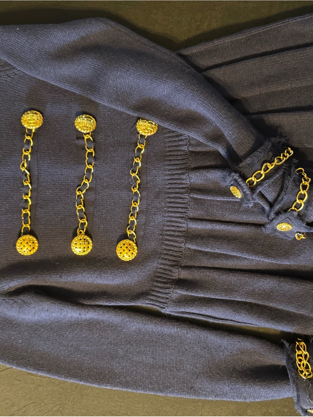 navy blue sweater with military inspired hardware design